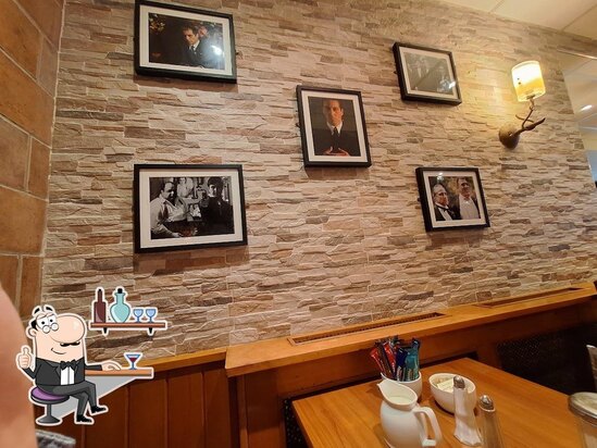 Framed photographs and warm wood inside Tony’s Bistro